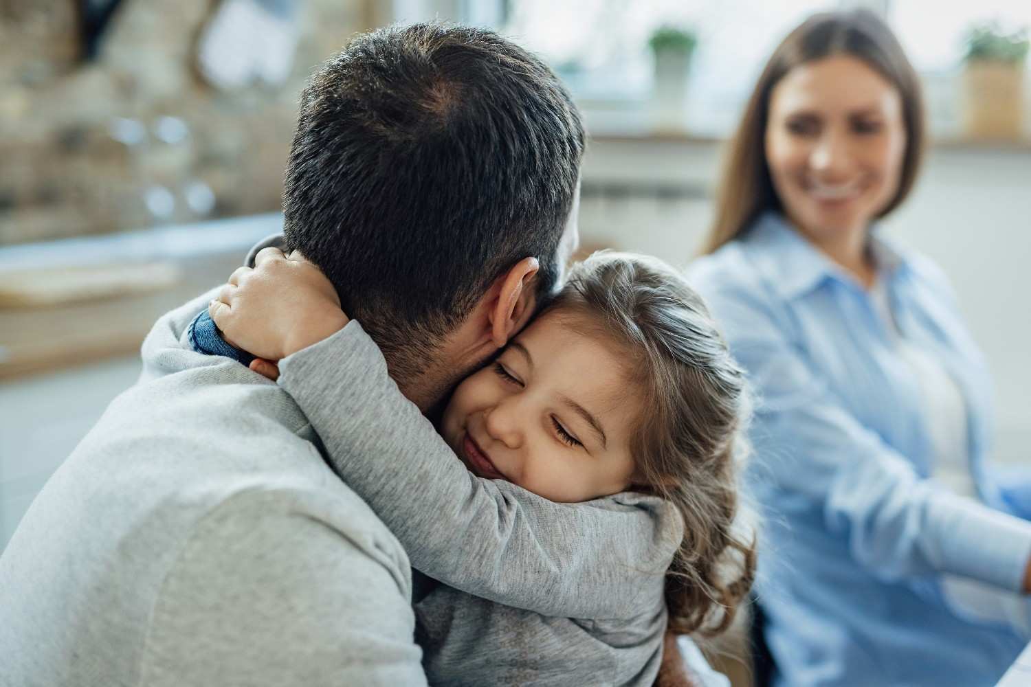 Foster father embracing his daughter in a warm family moment