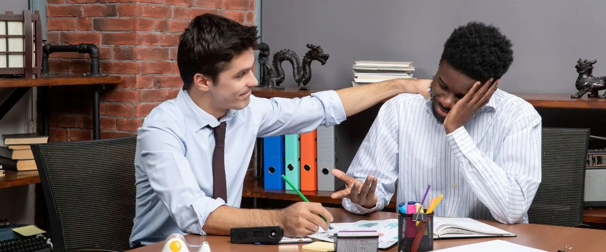 Manager discussing workload balance with a team member during a stress management meeting